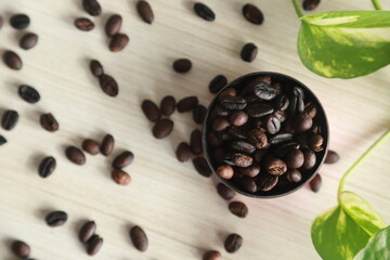 Top view of roasted coffee beans on a white table