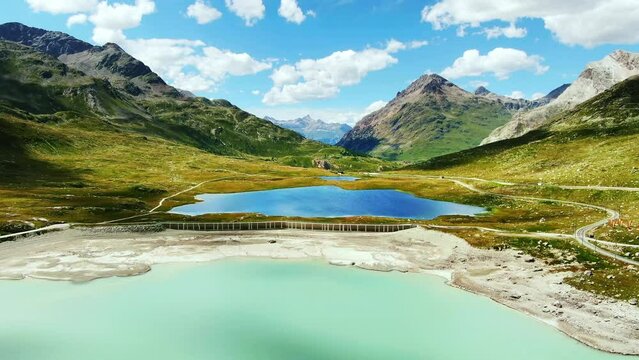 Drone Switzerland 4k. Bernese Oberland by Lake Bianco in Swiss Alps. Rhaetian Railway scenic route to St. Moritz. Switzerland summer tourism.