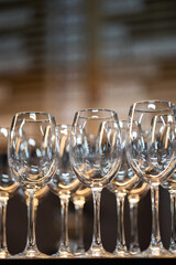 Vertical photo of empty wine glasses on the background of the bar. There are no people. Wine tasting