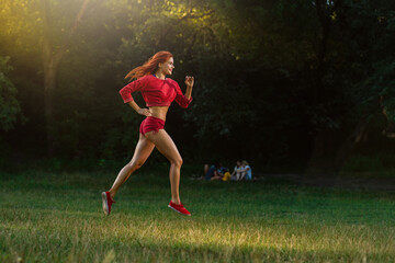 Slim athletic girl running outdoor in morning park for healthy lifestyle