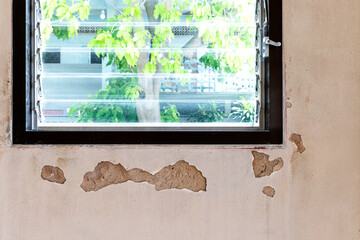 Texture concrete wall has cracks with louvre window