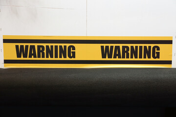 Warning word yellow and black color with line striped label banner