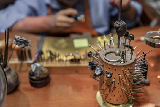 Silversmith working in an artisanal silversmith workshop in Florence, Italy