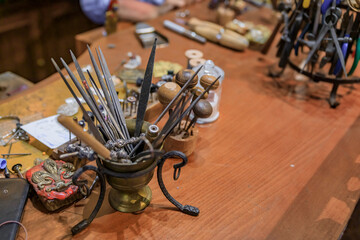 Metal working tools in an artisanal jeweler workshop studio in Florence, Italy