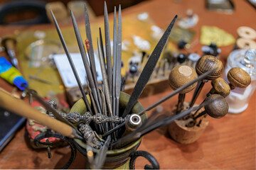 Metal working tools in an artisanal jeweler workshop studio in Florence, Italy