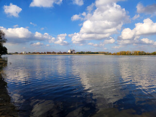 white clouds and blue sky reflected in the Danube river