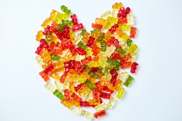 Flat lay tasty jelly bears candy of heart shape on white background, flat lay candy gummy bear, top view, copy space.