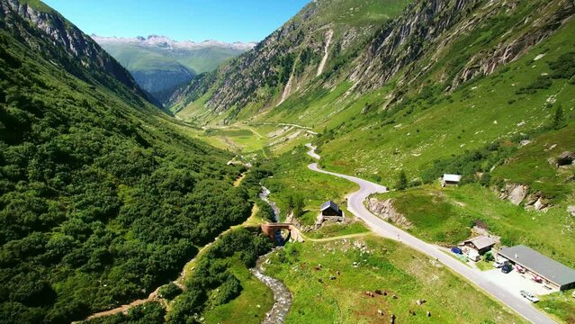 Drone Switzerland 4k. mountain pass winding roads in Swiss Alps. Road trip in valley in summer.