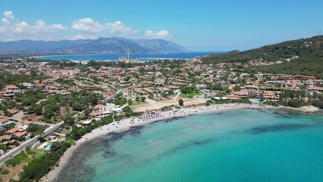 Arbatax Beach and Port in the background in Sardinia, Italy - Aerial 4k