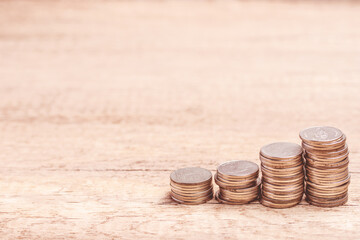 Coins stacked on brown background. Investment finance concept. Copy space.