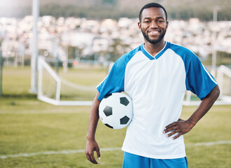 Sports, soccer and portrait of black man with ball and smile on face with motivation for winning game in Africa. Confident, proud and happy professional football player at exercise or training match.