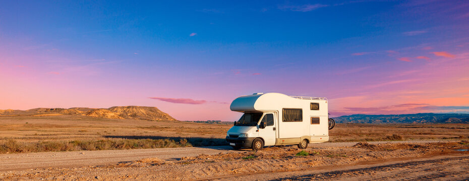 Motorhome at sunset on the road- travel,  adventure,  vacation concept