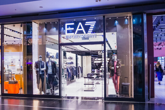 Emporio Armani EA7 store sign in shopping mall. Glass doors, showcase boutique, shop windows, mannequins. Astana, Kazakhstan - 10.24.2022.