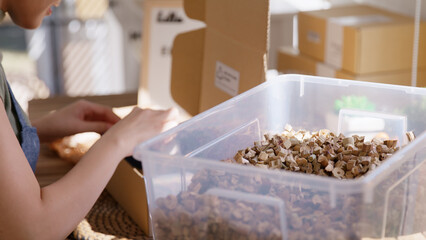 Eco vendor go green packaging parcel carton box in net zero waste store asian seller retail shop. Earth care day small SME owner asia people wrap reuse brown paper pack gift reduce plastic free order.