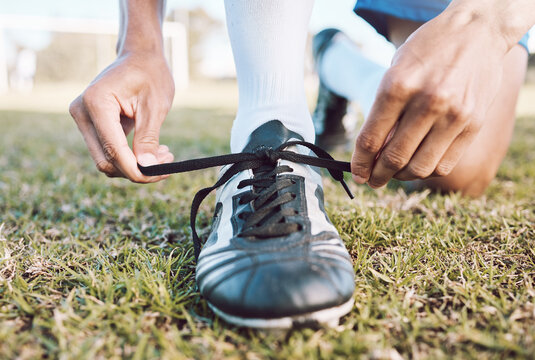 Sports, soccer field and man tie shoes for game, ready for training, workout and fitness outdoor. Male, guy or athlete tying shoe lace, before practice or exercise for wellness, cardio or competition