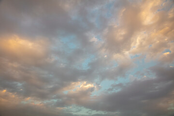 Naklejka na ściany i meble Afternoon sky with golden clouds
