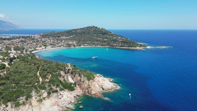 Arbatax Cove with Turquoise Blue Sea and Boat in Sardinia, Italy - Aerial 4k