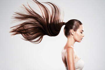 Profile portrait of a beautiful woman with a long straight  hair.