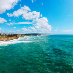 Beautiful oceanscape with skyline, ocean rocky coastline. Drone view over beaches, coastlines in Ericeira, Portugal, on summer sunny day. Aerial view to the Beautiful European touristic town.
