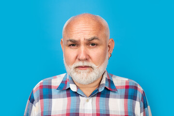 Fototapeta premium Grandfather pensioner, retiree concept. Closeup emotional portrait of an old mature senior man with grey beard isolated on studio background. Emotions faces.