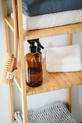 Fototapeta na wymiar Wooden rack in the bathroom with towels and bathroom accessories. Eco friendly, zero waste.