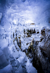 Stolactid icicles under ice. Winter