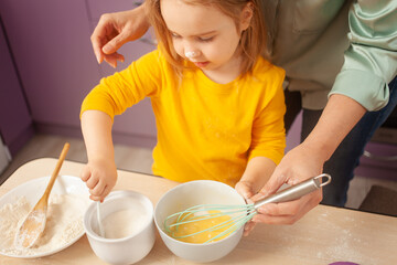 Grandmother and granddaughter prepare cake dough, spend time together, family relationships, love. gains sugar