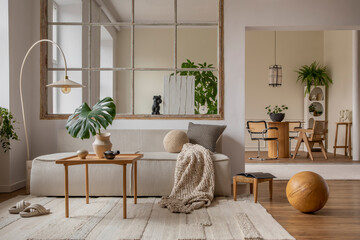 Interior design of open space interior with modular sofa, big window, stylish lamp, wooden coffee table, round table, rattan chair, pillows, plants and personal accessories. Home decor. Template.