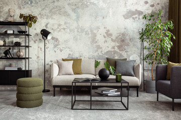 Creative composition of living room interior with gray sofa, stylish green pouf, black coffee table, rack, armchair, pillows, vase with dried flowers and personal accessories. Home decor. Template.