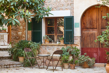 Traditional stone patio facade decorated with plants in Mallorca, Spain