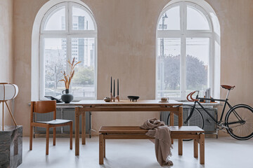 Creative composition of dining room interior design with wooden family table, armchair, bike and...
