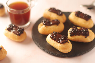 Traditional French dessert - eclairs with a cup of coffee