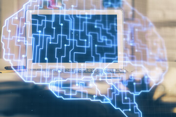 Double exposure of work space with computer and human brain drawing hologram. Brainstorm concept.