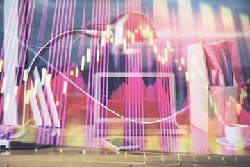 Financial market graph hologram and personal computer on background. Double exposure. Concept of forex.