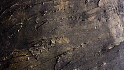 Microtexture dark rough sections with shiny gold