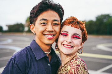 Young diverse friends having fun outdoor - Focus on gay asian guy wearing make-up