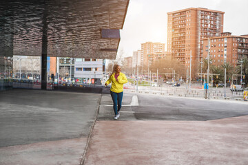 Senior african woman running outdoor - Focus on face