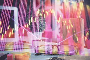 Financial chart hologram with glasses on the table background. Concept of business. Double exposure.