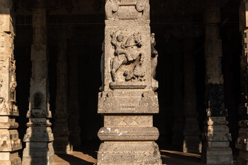 Beautiful stone carvings of a hero deity on pillar of an ancient Hindu temple near Kumbakonam in...