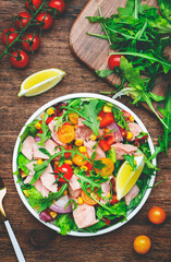 Fresh tuna vegetables salad with colorful cherry tomatoes, red onion, sweet corn, paprika, lettuce,...