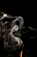 burnt match and smoke swirling 