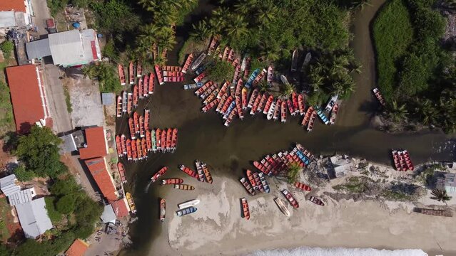 Overhead aerial shot of boats grouped together and stopped at the port of Chuao, Aragua state, Venezuela.