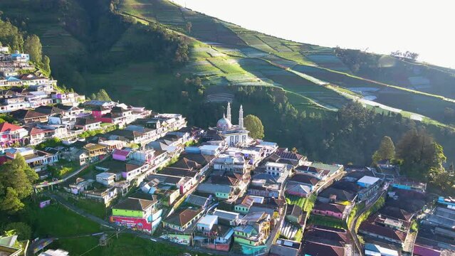 Aerial view of Dusun Butuh known as Nepal Van Java in Indonesia in the morning. The houses are hits by the sunlight - Rural landscape on the slope of Mount Sumbing