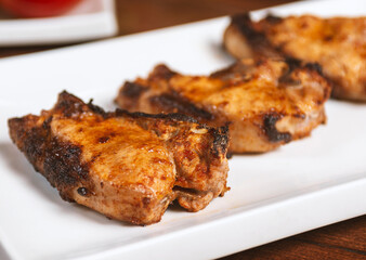 delicious grilled pork steaks on a white plate