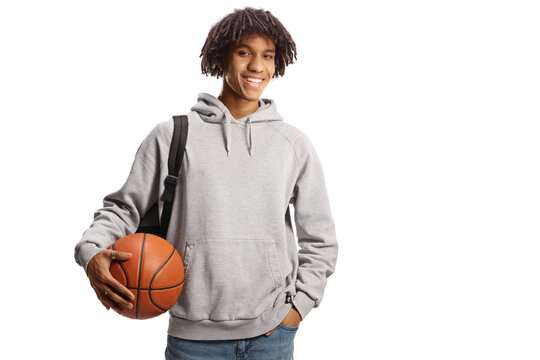 Young african american male with a backpack holding a basketball and smiling