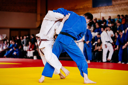 judo fighters on tatami fight in judo competition
