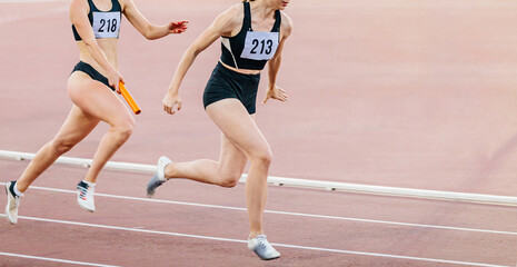 women relay race running track and field competition