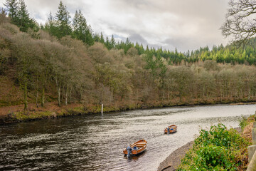 two boats on a river in the forest