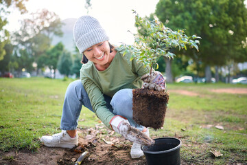 Community service, volunteering and woman plant trees in park, garden and nature for...
