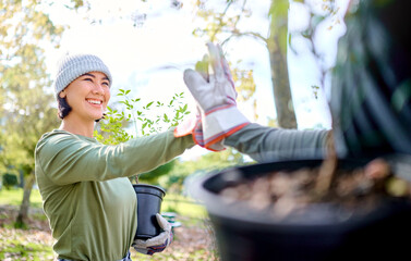 High five, gardening and team on a farm or park and celebrating plant growth for sustainability in the environment. Volunteer, woman and people excited for community service and teamwork in a garden